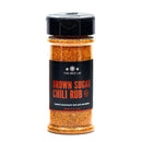 A 5 oz. jar of The Spice Lab Brown Sugar Chili Rub features an orange-hued seasoning that delivers a smoky BBQ flavor, making it ideal for beef, pork, and chicken.