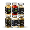 The Spice Lab Organic Starter Spice Set - 6 Jars features six glass jars of USDA Certified Organic spices from The Spice Lab, arranged in two rows. Clearly visible labels include granulated garlic, paprika, black pepper, sweet basil, granulated onion, and oregano leaf. This spice set is an ideal Organic Starter Spice Set or a thoughtful gift for any home chef.