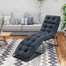 The DirectDeals Outdoor Lounge Chaise Cushion Set of 2 - 73x22 Inch High Back in dark gray adds comfort and style to a cozy living room with a sofa, patterned pillows, coffee table, and decorative plants on a wooden floor.
