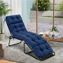 A DirectDeals Outdoor Lounge Chaise Cushion Set of 2 - 73x22 Inch High Back in blue sits on a rug near a small table with drinks, by glass doors overlooking a gravel garden with plants.