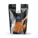 A black resealable bag of The Spice Lab Spicy Italian Sun-Dried Tomato Seasoning by The Spice Lab, showcasing an image of the seasoning and a wooden spoon on the front, ideal for bringing savory Italian flavor to your favorite dishes.