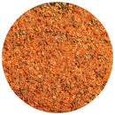 Close-up of a round pile of The Spice Lab Spicy Seafood Seasoning, a vibrant orange-red blend with visible dried green herbs, showing its coarse and textured mix—ideal for adding Cajun-inspired heat to all your favorite coastal recipes.