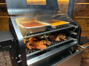 A two-tiered Pimp My Grill® Gen2 Slide-Out Rack System inside a pellet grill, holding two pans of food on the top rack and two whole chickens on the bottom.