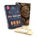The Spice Lab Tequila Himalayan Salt Shooters Gift Set by The Spice Lab includes four cocktail shooter glasses crafted from Himalayan salt, a wooden serving tray, and comes packaged in a brown box decorated with vibrant sugar skull designs.