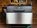 A Green Mountain Grills Jim Bowie / Peak | Pimp My Grill® Stainless Steel Shelf Extension / Sleeve attached to the front of a pellet grill lid.