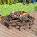 The DirectDeals 8-Person Round Picnic Table Set Circular Patio Dining Camping Table with Benches is set on a patio for outdoor dining, surrounded by grass, plants, and garden décor.