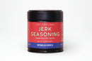 A 2.05 oz (58g) jar of World Spice Jerk Seasoning from World Spice features a red and blue label reading "Jerk Seasoning Handcrafted Blend" and "World Spice." This handcrafted blend captures the bold, citrusy brightness and warm, comforting heat of Caribbean flavors—making it the perfect way to add authentic zest to your next barbecue. The label highlights notes of heat, citrus, and warmth.