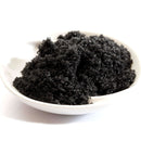 A white bowl containing The Spice Lab Hawaiian Black Lava Salt Fine Grain from The Spice Lab is set against a white background.