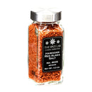 A clear glass jar with a silver lid contains medium grain Hawaiian Red Alaea Sea Salt, prized for its distinctive earthy flavor. The black label displays “The Spice Lab Hawaiian Red Alaea Sea Salt Medium Grain, No. 4035,” Net Wt. 4.2 oz.