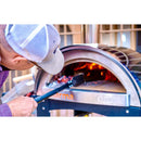 A person wearing a cap uses the WPPO Coal Rake for Wood-Fired Pizza Oven by WPPO LLC Direct to tend to wood and flames inside a wood-fired pizza oven labeled "Karma" and "WPPO.