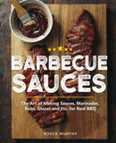 Barbecue Sauces: The Art of Making Sauces, Marinades, Rubs, Glazes and Etc. for Real BBQ - Paperback by Roger Murphy from Books by splitShops features mouthwatering grilled ribs, a bowl of sauce, and a brush on a wooden board. Discover flavorful BBQ sauces and barbecue rubs to elevate your grilling experience with this comprehensive cookbook.