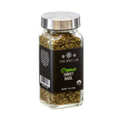 A glass jar of The Spice Lab Organic Sweet Basil, featuring a silver lid and black label, contains 0.5 oz (14g) of dried basil leaves—ideal for adding Italian-inspired flavor to your dishes.