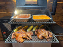 Two whole roasted chickens and four ears of corn sit on a Pimp My Grill® Gen2 Slide-Out Rack System for Green Mountain Grills Ledge / Daniel Boone, with two foil pans of side dishes on the top rack.