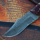 Close-up of the Texan Knives Best Knives for Hunting, featuring an 8.5" Damascus steel blade and pine cone resin handle, resting on a textured surface—an excellent hunting knife with included leather sheath.