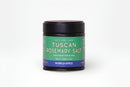 A 2.68 oz (76g) jar of World Spice Tuscan Rosemary Salt by World Spice, featuring a green label and black lid. This handcrafted blend is ideal for enhancing classic Tuscany dishes and pairs wonderfully with extra virgin olive oil and local wines.
