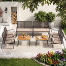 The DirectDeals 8-Piece Patio Conversation Set with Acacia Wood Coffee Table features two benches, four chairs, a coffee table on a rug, plus fruit, drinks, firewood, flowers, and a tree for the perfect outdoor scene.