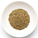 A white bowl filled with The Spice Lab Whole Celery Seeds, known for their use as savory seasoning, photographed from above on a white background.