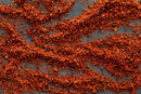 World Spice Tar Heel BBQ Rub from World Spice scatters in vibrant, wavy patterns across a dark gray surface, evoking the rustic charm and textured appearance of Carolinas barbecue with its rich color contrast reminiscent of classic vinegar BBQ sauce and authentic pork BBQ rubs.