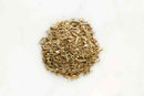 A small pile of World Spice Poultry Rub by World Spice, a flavorful blend of Italian herbs and spices ideal for seasoning chicken or using as a poultry rub, is scattered on a white surface.