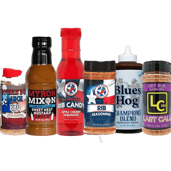 Seven assorted bottles and jars of barbecue sauces, seasonings, and dry rubs are displayed in a row, each with distinct colorful labels and branding on a white background.
