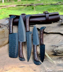 Five Texan Knives from the Best Budget Knife Set, featuring forged stainless steel blades, wenge wood handles, and a leather sheath, are displayed outdoors on wood with grass in the background.