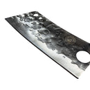A close-up of the Spaceman Knives Meteor Series Kitchen Cleaver, featuring a textured hammered blade with a round hole near the handle, designed for precise meat chopping, resting on a white marble surface.