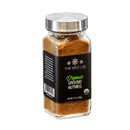 A jar of The Spice Lab Organic Ground Nutmeg, featuring a silver lid and a black label with product details—ideal for infusing warm, aromatic flavor into eggnog and all your holiday baking.