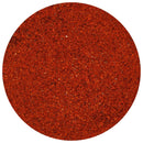 A close-up view of The Spice Lab Guajillo Chile Powder within a circular frame, highlighting its vibrant, reddish-orange color and slightly coarse texture—a staple ingredient in authentic Mexican cooking and seasoning blends from The Spice Lab.