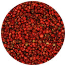 A close-up shot of numerous small, round The Spice Lab Pink Pepper Berries (Whole) Brazilian Pink Peppercorns, tightly packed together and photographed within a circular frame.