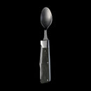 The Messermeister Adventure Chef Linen Folding Camp Utensil, a metal spoon with a multitool-style handle and textured dark grip, is shown upright against a solid black background.