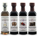 The Georgetown Olive Oil Co Aged Balsamic Collection by Georgetown Olive Oil Co. features four elegantly presented bottles of premium aged Italian balsamic vinegar, each labeled to reflect its aging: 12, 18, 18 Platinum, and 25 years. The collection displays distinct bottle designs arranged side by side for a refined presentation.