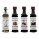 Four bottles from the Georgetown Olive Oil Co. Aged Balsamic Collection, each featuring a distinct age—12, 18, and 25 years—stand upright in a row against a white background. This impressive set by Georgetown Olive Oil Co. highlights the rich tradition and complex flavors of genuine Italian balsamic vinegar.