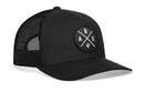 The Haka Hat Albuquerque Trucker Hat in black features a mesh back, curved brim, and an ABQ X patch with white letters and a trident on the front. Brand: Haka Hat.