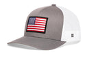 Show your patriotic spirit with the Haka Hat American Flag Trucker Hat—a gray and white USA snapback featuring a mesh back and front flag patch.