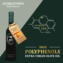 A bottle of Georgetown Olive Oil Co. Green Arbequina (SPAIN) Extra Virgin Olive Oil features the Georgetown Olive Oil Co. label and a tag indicating its Spanish Arbequina origin. The text highlights its high polyphenol content of 294 mg/kg, emphasizing the exceptional quality of this first cold-pressed olive oil. Science-themed graphics in the background underscore its Spanish olive oil heritage.