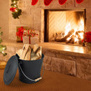 A DirectDeals Ash Bucket with Lid and Cut-resistant Gloves filled with firewood sits on a carpet by a lit stone fireplace, surrounded by holiday decorations, stockings, and a gift box for a cozy festive atmosphere.