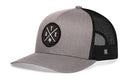The Haka Hat Austin Trucker Hat in gray-black features an ATX X embroidered patch with Texas outline, a comfort-fit snapback, curved brim, and mesh back for breathability and style.