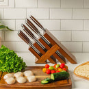 The Messermeister Avanta Pakkawood Knife Block Set - 10 Piece by Messermeister holds stainless steel knives on the counter. In front, fresh scallops, lettuce, cucumber slices, cherry tomatoes, and bread sit on a wooden cutting board.