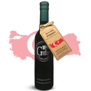 A bottle of Georgetown Olive Oil Co. Ayvalik (TURKEY) Extra Virgin Olive Oil—an acclaimed Turkish olive oil from Georgetown Olive Oil Co. with a medium-mild intensity—is displayed with a tag featuring the Turkish flag and information on its fresh harvest, origin, and polyphenol content, set against a vibrant red map of Turkey.