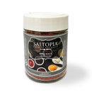 A clear jar of SALTOPIA Infused Sea Salts, labeled "BBQ Salt: MEAT HEAD," filled with Texas BBQ seasoning. The white-lidded jar shows images of spices and sauces. Net weight: 4 oz (113g).