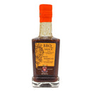 A glass bottle of Taycte Aged Balsamic Steak Sauce features an orange label and cap. The label displays “Steak Sauce with 25-30 Year Balsamic Vinegar of Modena” in both English and Spanish, emphasizing its Italian steak sauce inspiration. The bottle contains 8.5 oz of sauce from the Taycte brand.