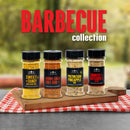 Four spice jars from The Spice Lab Barbecue Seasoning Collection—Sweet + Tangy, Brown Sugar Chili Rub, Polynesian Pineapple, and Smoked Butchers Blend—are displayed on a board with “BARBECUE collection” text above, set atop a red-checked cloth in an outdoor setting. This premium barbecue seasoning set by The Spice Lab makes the perfect grilling gift or a flavorful addition for anyone looking to elevate their meals.