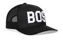 The Haka Hat Boston White Block Trucker Hat is a black snapback with mesh sides and "BOSS" in bold white letters, offering an adjustable fit.