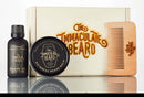 Introducing the Immaculate Premium Beard Grooming Gift Set For Men by The Immaculate Beard—a complete care kit including nourishing beard oil, conditioning beard balm, and a handcrafted wooden comb, all elegantly arranged in front of a matching wooden box adorned with the iconic brand logo.