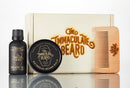 Introducing the Beard Grooming Gift Set by The Immaculate Beard—a complete beard care set that includes beard oil, beard balm, a wooden comb, and a stylish wooden box. Both the box and comb feature engraved The Immaculate Beard logos, offering an unmistakable touch of class.