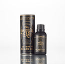 A bottle of The Immaculate Beard’s Conditioning Natural Beard Oil sits beside its sleek cylindrical packaging, both adorned with gold text on a white background and highlighting natural ingredients such as spearmint, eucalyptus, and lavender. This premium beard oil by The Immaculate Beard also serves as a nourishing conditioner, keeping your facial hair soft and healthy throughout the day.