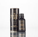 A bottle and cylindrical container of The Immaculate Beard Conditioning Natural Beard Oil are displayed on a white background. Featuring black packaging with gold and white text, this premium beard oil from The Immaculate Beard is labeled sandalwood and vanilla scent, highlighting its role as an essential conditioner for maintaining a soft, well-groomed beard.
