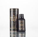 A black bottle and matching tube container labeled “The Immaculate Beard Conditioning Natural Beard Oil” with gold text stand side by side on a white background. Both state “No Fragrance Added” and “1 oz (28g)” and are formulated as nourishing beard oil and effective conditioner by The Immaculate Beard.