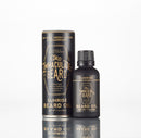 A bottle and cylindrical container of The Immaculate Beard Conditioning Natural Beard Oil, featuring gold text highlighting the scent, conditioning benefits, and product weight from The Immaculate Beard brand, displayed on a white background.