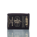 Introducing the Natural Beard Wash Bar | Beard Shampoo by The Immaculate Beard in the Dark variety. Presented in sleek black packaging, this natural beard care essential highlights captivating notes of tobacco blossom, caramel, honey, and rose. Ideal for use as a beard shampoo bar, it embodies both quality and sophistication—with its reflection elegantly visible beneath the product.